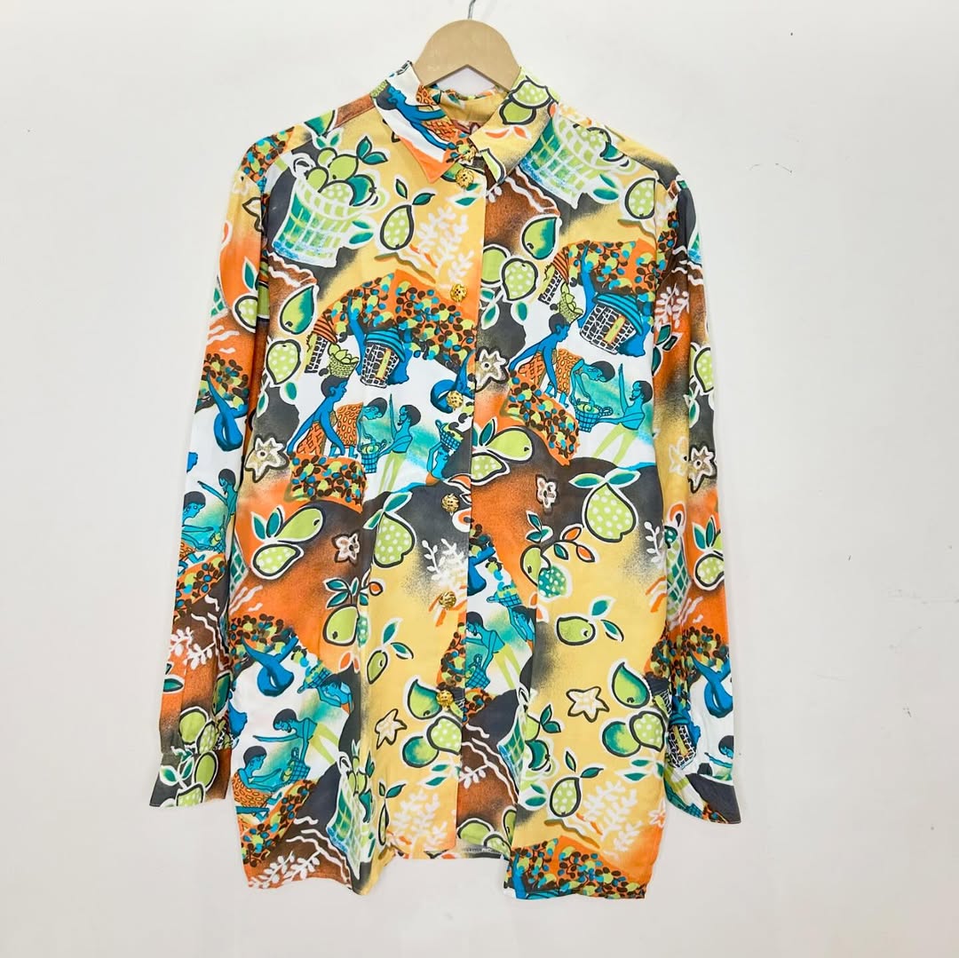 Colorful patterned shirt on a hanger against a white background