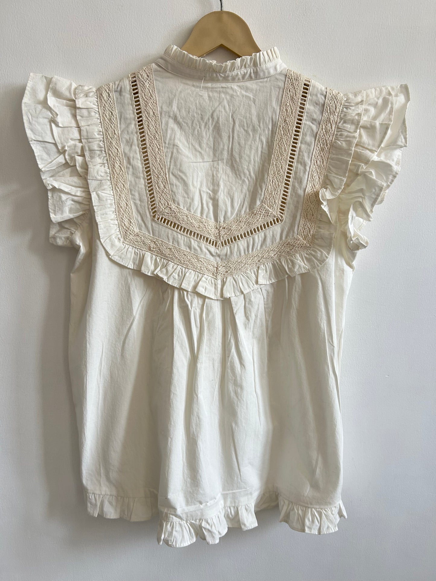 White sleeveless ruffle top