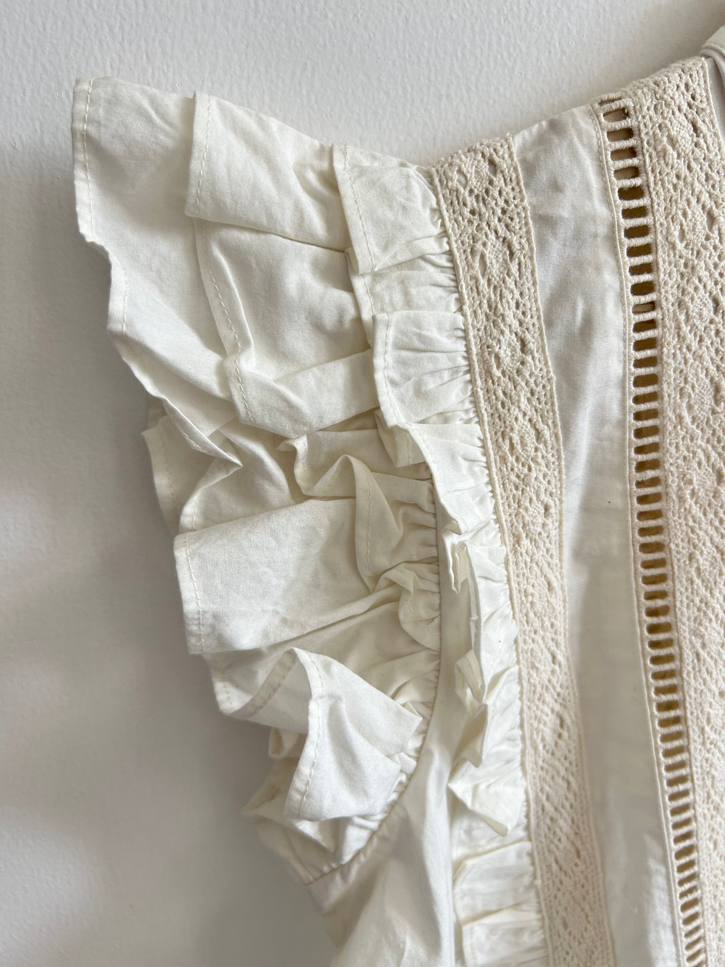 White sleeveless ruffle top