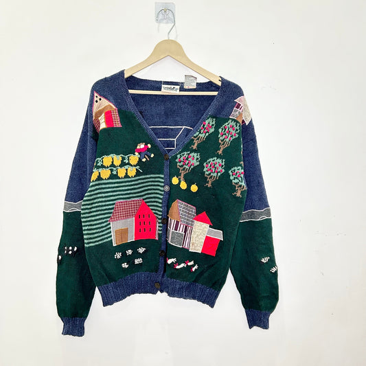 Colorful cardigan with house patterns on a white background