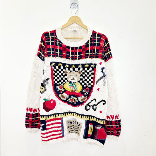 Colorful sweater with various patterns and designs on a white background