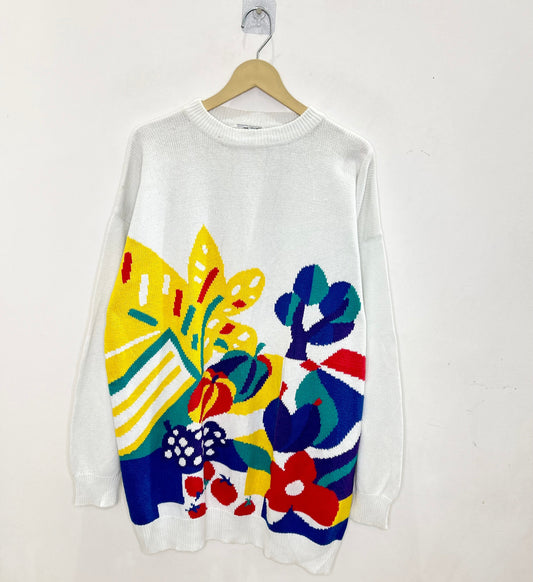 White sweater with colorful floral patterns on a white background